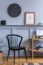 Stylish scandinavian living room interior with design black chair, wooden console, plants, books, decoration, mock up poster map Royalty Free Stock Photo