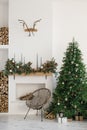 Stylish Scandinavian minimalistic Christmas interior with fireplace and Christmas tree. Cozy house. Modern interior of a country