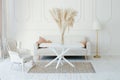 Stylish Scandinavian modern white cozy eco interior in minimalist style. Modern home decor with Pampas grass in vase. Open space. Royalty Free Stock Photo