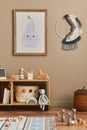 Stylish scandinavian newborn baby room with brown wooden mock up poster frame, toys, doll and child accessories. Cozy decoration.