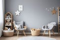 Stylish scandinavian newborn baby room with toys, children's chair, natural basket with teddy bear and small shelf Royalty Free Stock Photo