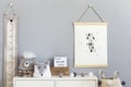 Stylish scandinavian nursery interior with hanging mock up poster, natural toys, teddy bears, children`s accessories and design Royalty Free Stock Photo