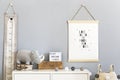 Stylish scandinavian nursery interior with hanging mock up poster, natural toys, teddy bears, children`s accessories and design Royalty Free Stock Photo