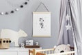 Stylish scandinavian nursery interior with hanging mock up poster, natural toys, teddy bears, children`s accessories and design Royalty Free Stock Photo