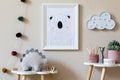 Playroom for kids with cute toys and mockup poster frame in Scandinavian style.