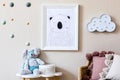 Playroom for kids with cute toys and mockup poster frame in Scandinavian style