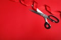 Stylish scissors and red ribbon, flat lay with space for text. Ceremonial tape cutting