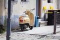 Stylish scooter staying parked near old house