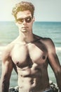 Stylish seducer man at sea. Fashion sunglasses and hair style Royalty Free Stock Photo