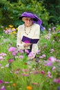 Stylish senior woman reading outdoors