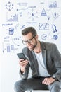stylish SEO developer in gray suit using smartphone Royalty Free Stock Photo