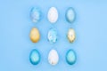 Stylish Set of blue, white and gold easter eggs isolated on light blue background. Easter concept, top view Royalty Free Stock Photo