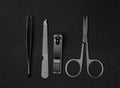 Stylish set of stainless manicure and pedicure tools isolated on black background. Classic metal kit of nail scissors Royalty Free Stock Photo