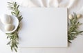 Stylish setting wedding table with place card with olive branch and eucalyptus leaves on white tablecloth Royalty Free Stock Photo