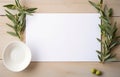 Stylish setting wedding table with place card with olive branch and eucalyptus leaves on white tablecloth Royalty Free Stock Photo