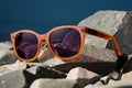 Stylish shades rest on a solid rock, blending fashion with nature