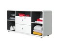 Stylish shelving unit with clothes and shoes on white background.