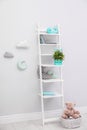 Stylish shelving unit near wall in child room