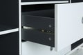 Stylish shelving unit with open drawer, closeup.