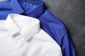 Stylish shirts on grey stone table, closeup. Dry-cleaning service Royalty Free Stock Photo
