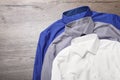 Stylish shirts on wooden table, flat lay. Dry-cleaning service Royalty Free Stock Photo