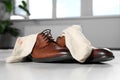 Stylish shoes with dirty socks on white wooden floor indoors, closeup Royalty Free Stock Photo