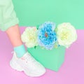 Stylish shoes and roses. White Sneakers. Minimal Summer mood concept. Ideal for bloggers, websites, magazines, business Royalty Free Stock Photo