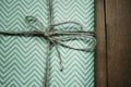 Stylish simple wrapped gift for holidays, with lines, on woode