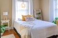 Stylish small bedroom decorated in yellow and white