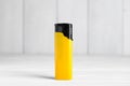 Stylish small pocket lighter on white wooden table Royalty Free Stock Photo