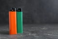 Stylish small pocket lighters on grey table, space for text Royalty Free Stock Photo