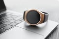 Stylish smart watch on laptop, closeup view Royalty Free Stock Photo