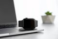 Stylish smart watch and laptop on grey table, closeup Royalty Free Stock Photo