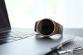 Stylish smart watch and laptop on table Royalty Free Stock Photo