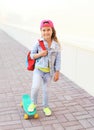 Stylish smiling little girl child riding skateboard Royalty Free Stock Photo