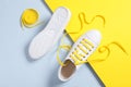 Stylish sneakers with yellow shoe laces on color background, flat lay Royalty Free Stock Photo