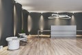 Stylish spacious welcome area in modern interior design office with grey reception desk on dark illuminated wall background and Royalty Free Stock Photo