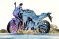 Stylish sports motorcycle with foam on the self-service car wash at sunrise. Royalty Free Stock Photo