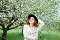 Stylish spring bohemian outfits. Wearing a white sweater and bla