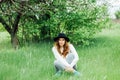 Stylish spring bohemian outfits. Wearing a white sweater and bla