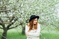 Stylish spring bohemian outfits. Wearing a white sweater and bla