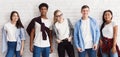 Stylish students posing over white wall, crop Royalty Free Stock Photo