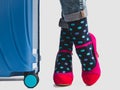 Stylish suitcase, women`s legs, bright socks and pink shoes Royalty Free Stock Photo