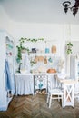 Stylish and sunny interior of kitchen space with small wooden table at the photo studio. Scandinavian room decor with kitchen