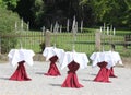 Stylish table decoration with candlestick in front of the castle park with an old fence