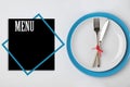 Stylish table setting and empty menu on background, top view. Space for text Royalty Free Stock Photo