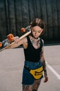 stylish tattooed girl with closed eyes holding skateboard over Royalty Free Stock Photo