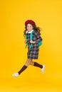 Stylish teen college student jumping. little girl with backpack going to school. education concept. school and fashion Royalty Free Stock Photo