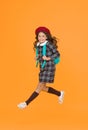 stylish teen college student jumping. little girl with backpack going to school. education concept. school and fashion Royalty Free Stock Photo
