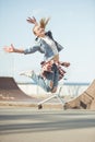 Stylish teenage girl jumping at skateboard park Royalty Free Stock Photo